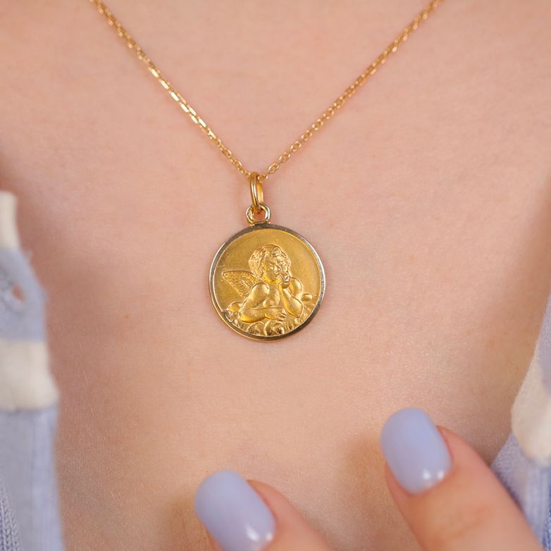 Angel medal in yellow gold...
